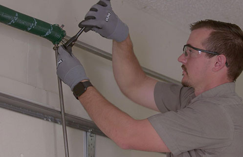 Technician Repairing Garage Door